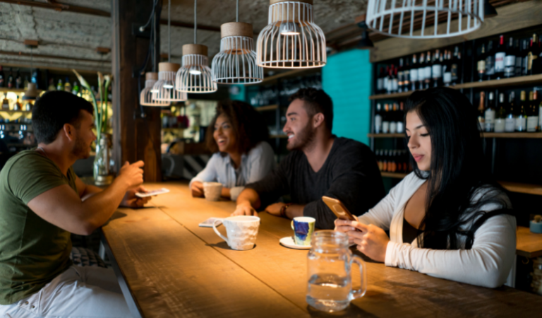person at restaurant looking at phone