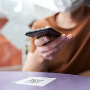 Person scanning Qr code on table