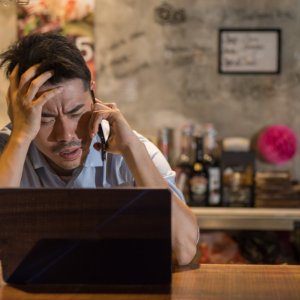 worker on the phone and using laptop