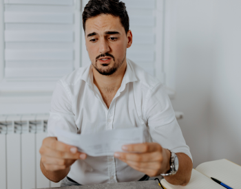 a man staring at his paycheck